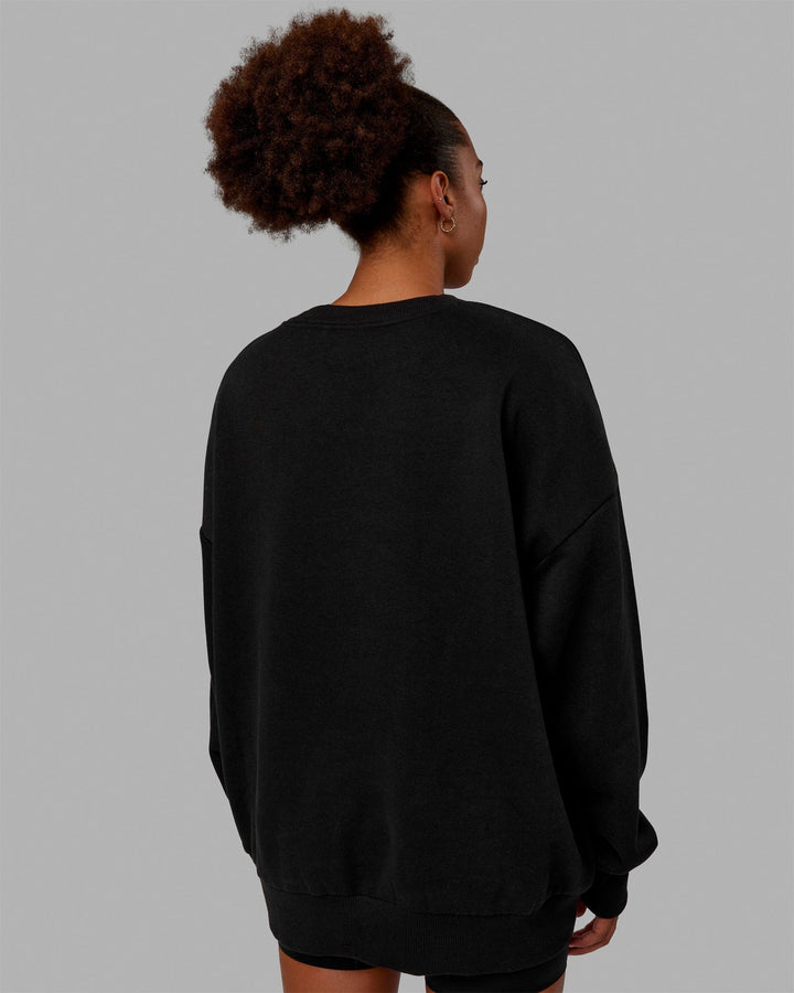 Woman wearing Unisex MVP Sweater Oversize - Black
