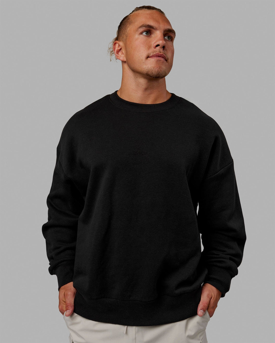 Man wearing Unisex MVP Sweater Oversize - Black