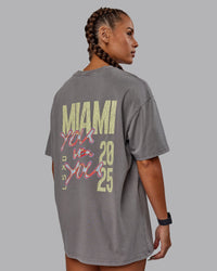 Woman wearing Unisex Miami25 Washed FLXCotton Tee Oversize - Storm Front-Lemon Fizz