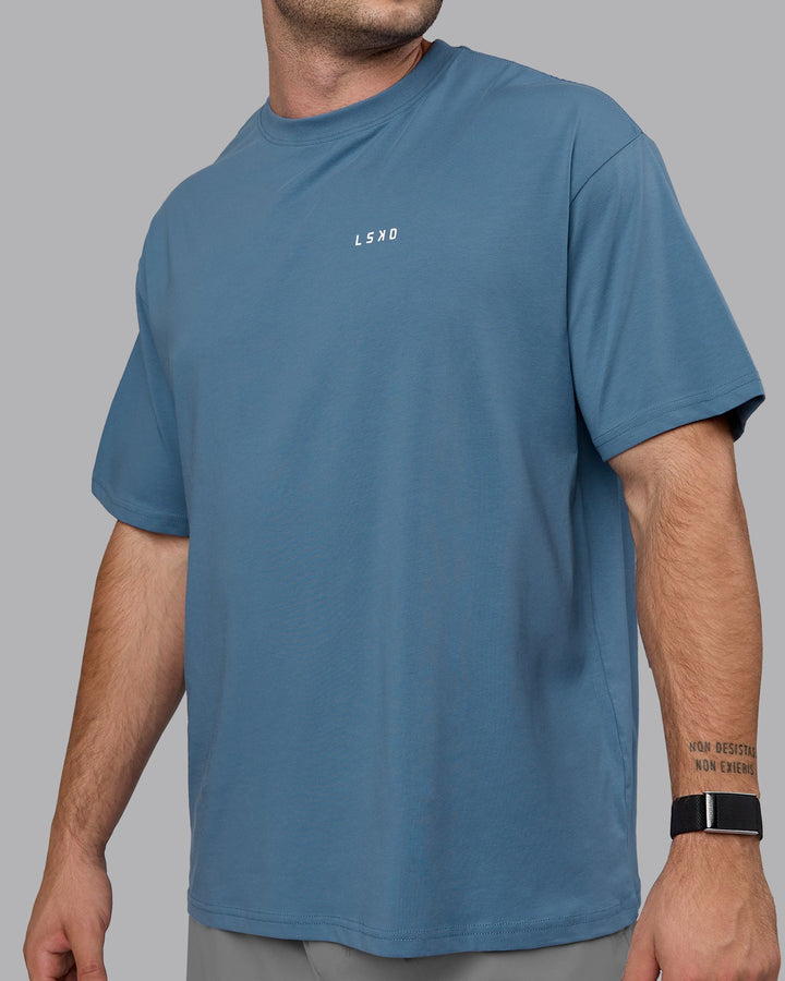 Man wearing Unisex Move Fast Value Series FLXCotton Tee Oversize - Elemental Blue-Off White
