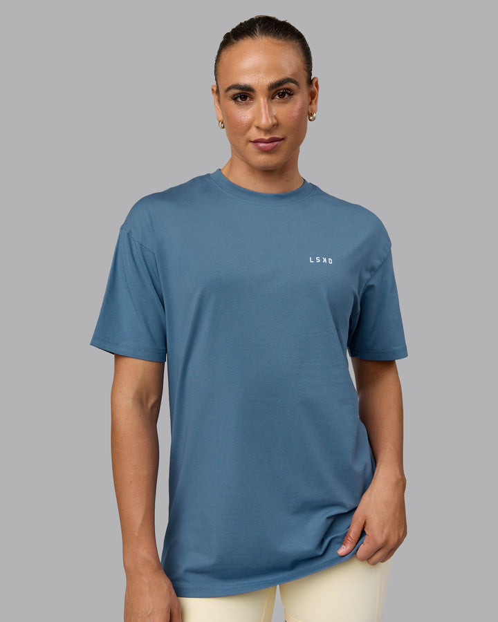 Woman wearing Unisex Move Fast Value Series FLXCotton Tee Oversize - Elemental Blue-Off White
