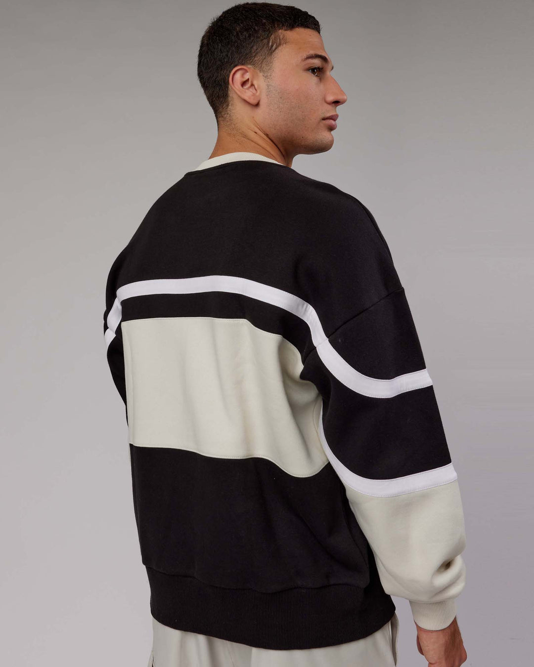 Man wearing Unisex PrimeTime Sweater Oversize - Black-Bone