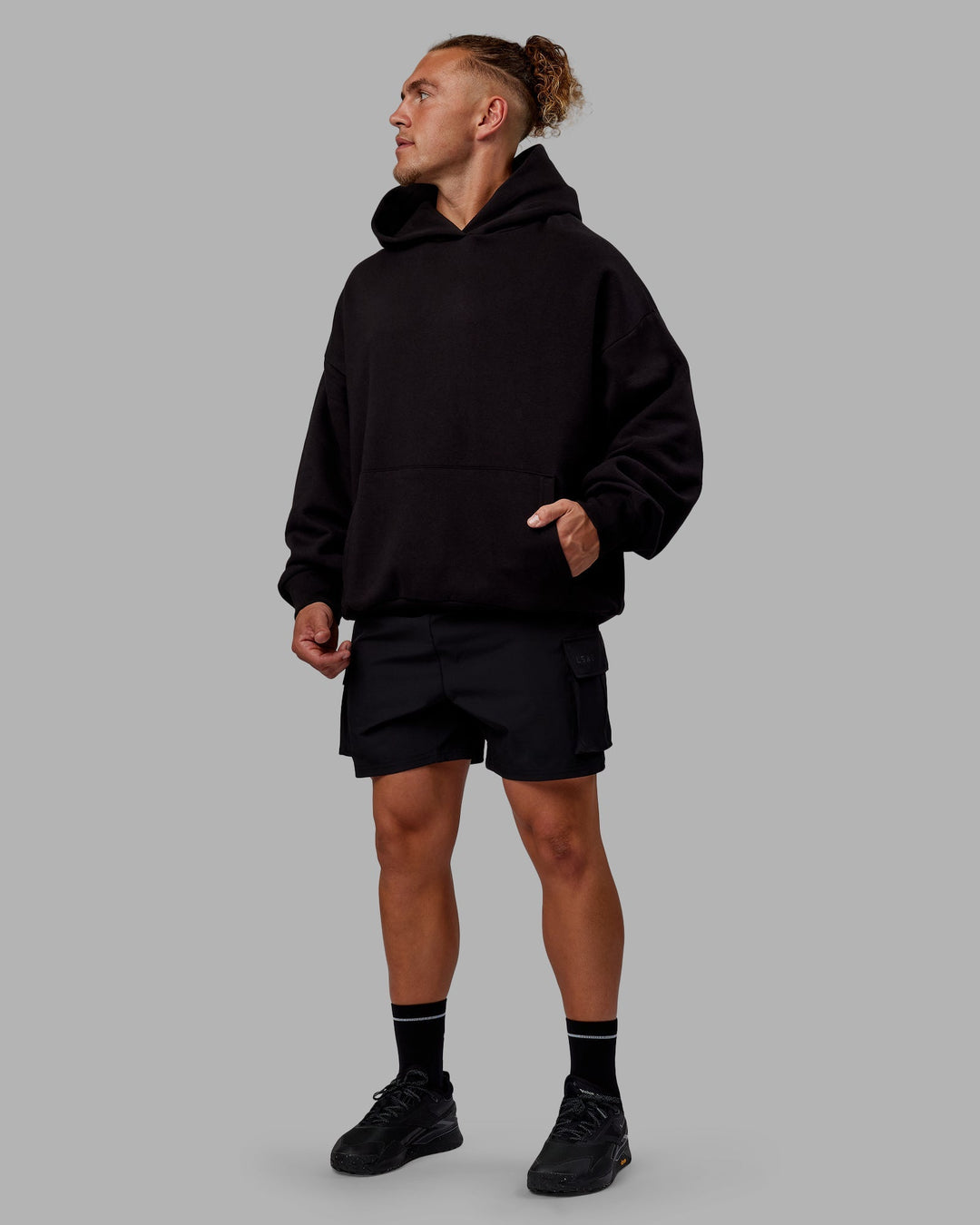 Man wearing Sara Unisex Hoodie Oversize - Black-Black