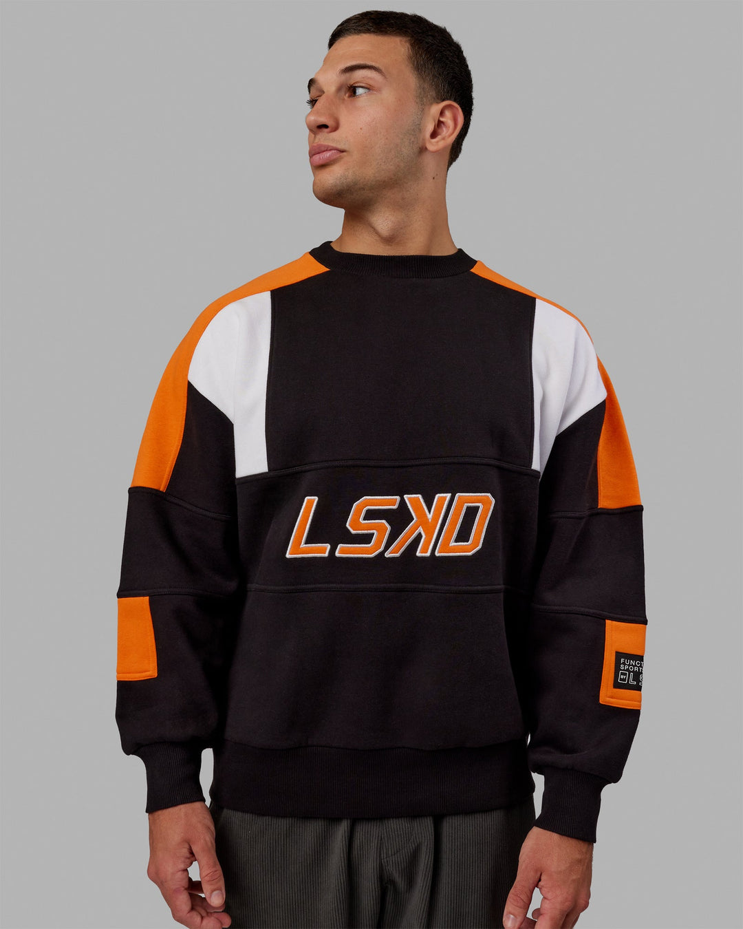 Man wearing Unisex Slam Sweater Oversize - Black-Ultra Orange