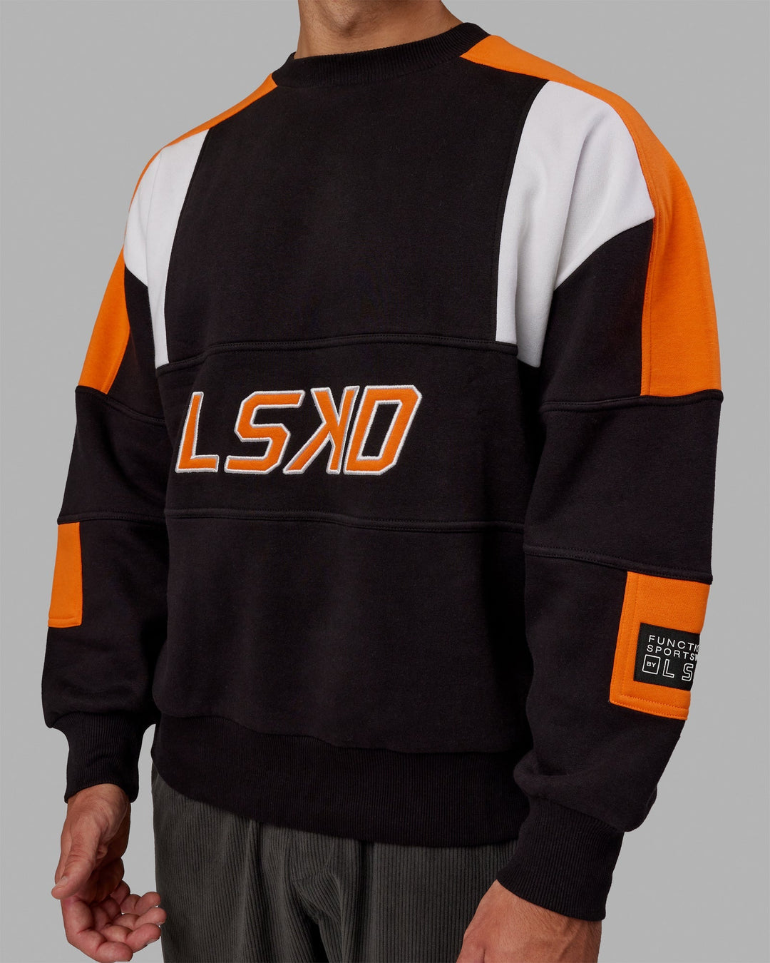 Man wearing Unisex Slam Sweater Oversize - Black-Ultra Orange