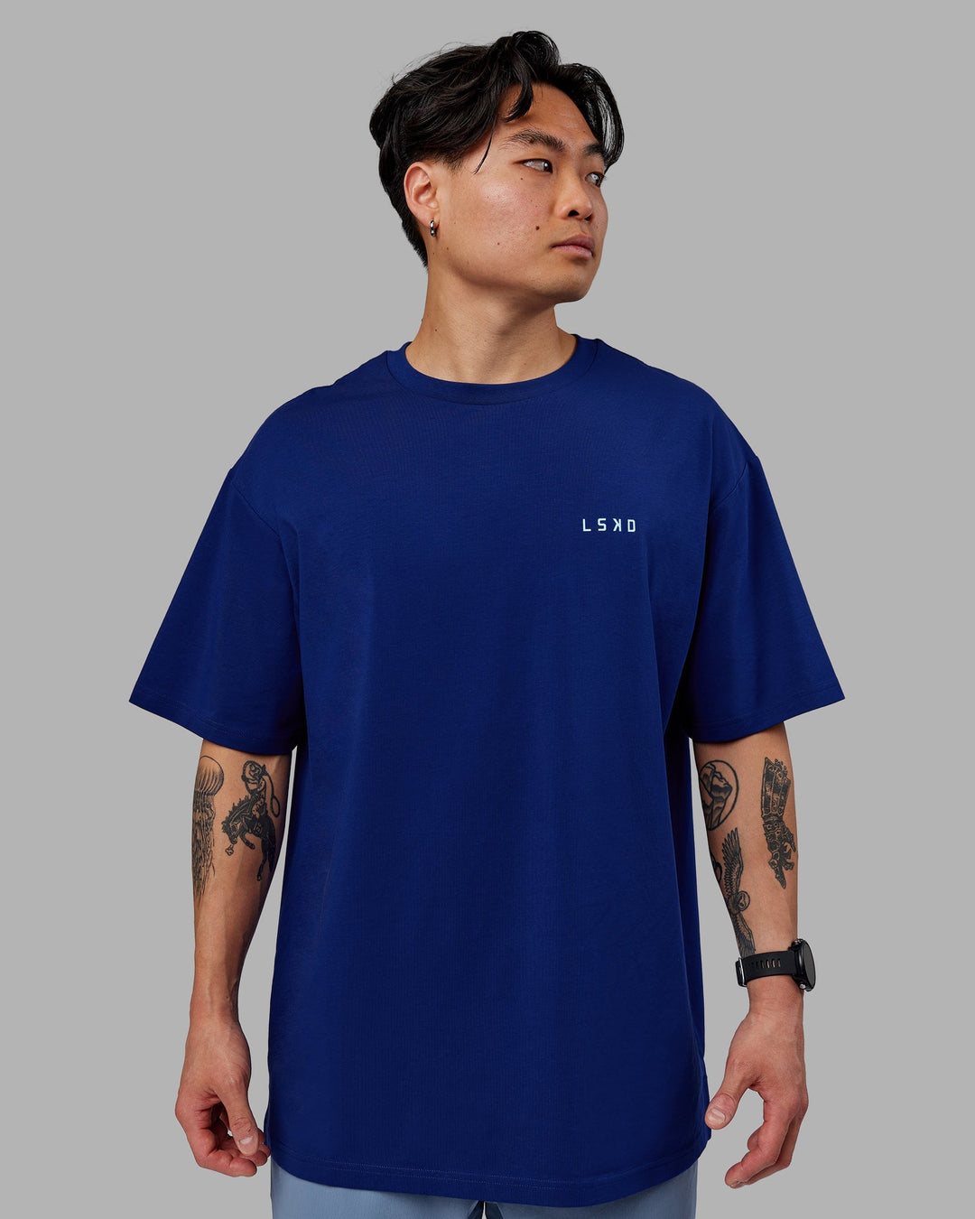 Man wearing Unisex Strike Through FLXCotton Tee Oversize - Midnight Blue-Glacial Blue