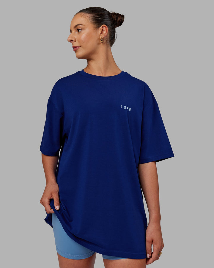 Woman wearing Unisex Strike Through FLXCotton Tee Oversize - Midnight Blue-Glacial Blue
