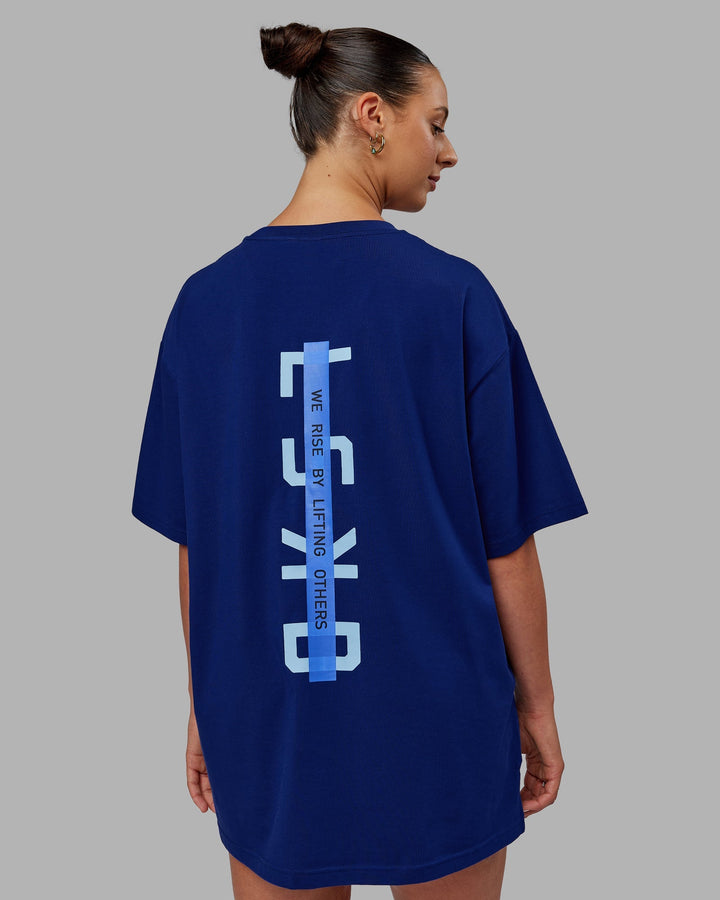 Woman wearing Unisex Strike Through FLXCotton Tee Oversize - Midnight Blue-Glacial Blue
