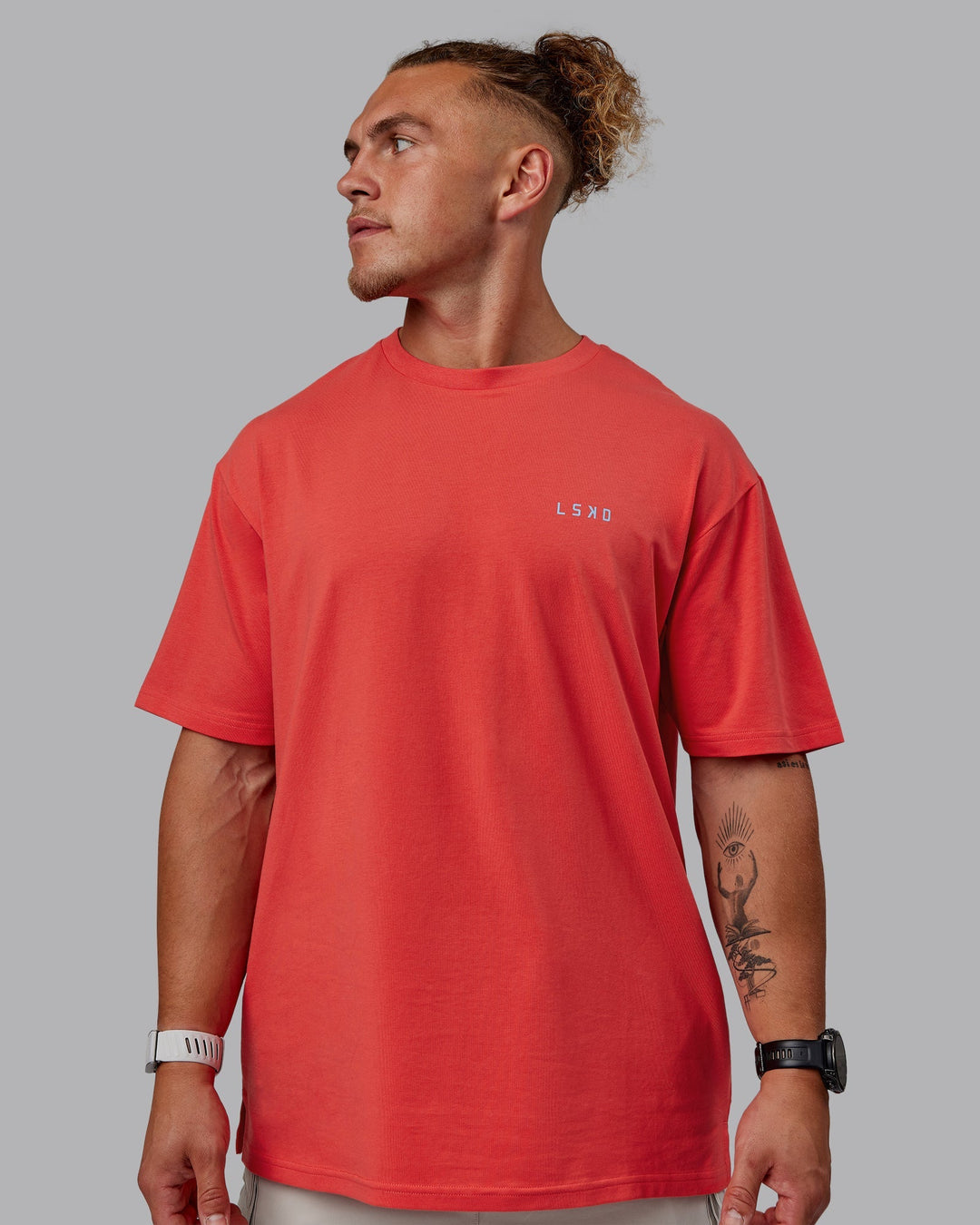 Man wearing Unisex Strike Through FLXCotton Tee Oversize - Cayenne-Glacial Blue