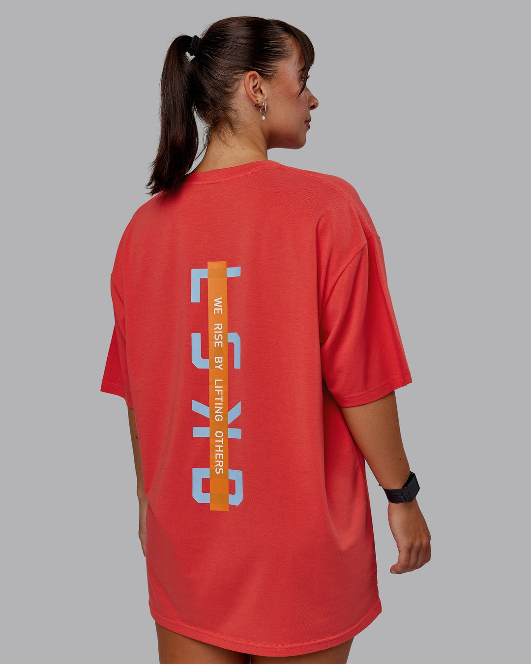 Woman wearing Unisex Strike Through FLXCotton Tee Oversize - Cayenne-Glacial Blue