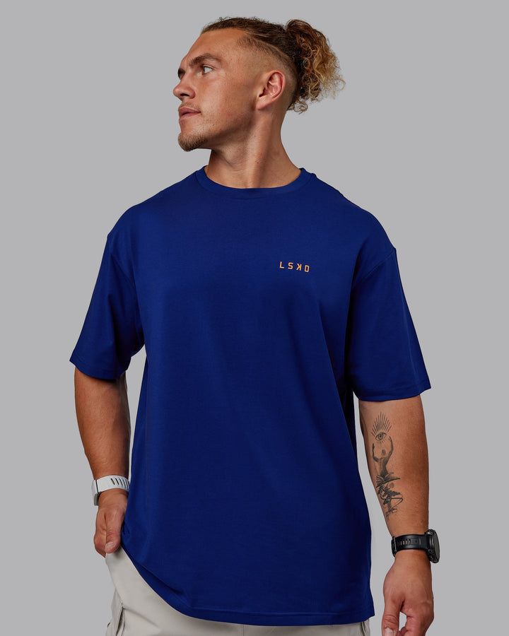 Man wearing Unisex Strike Through FLXCotton Tee Oversize - Midnight Blue-Vibrant Orange
