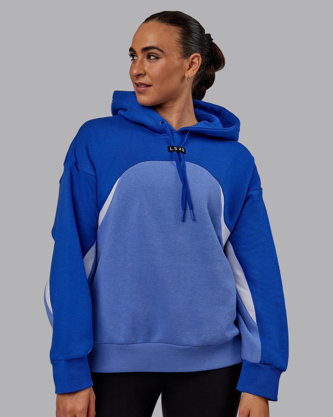 Woman wearing Unisex Y2K Concept Panel Hoodie - Power Cobalt-White