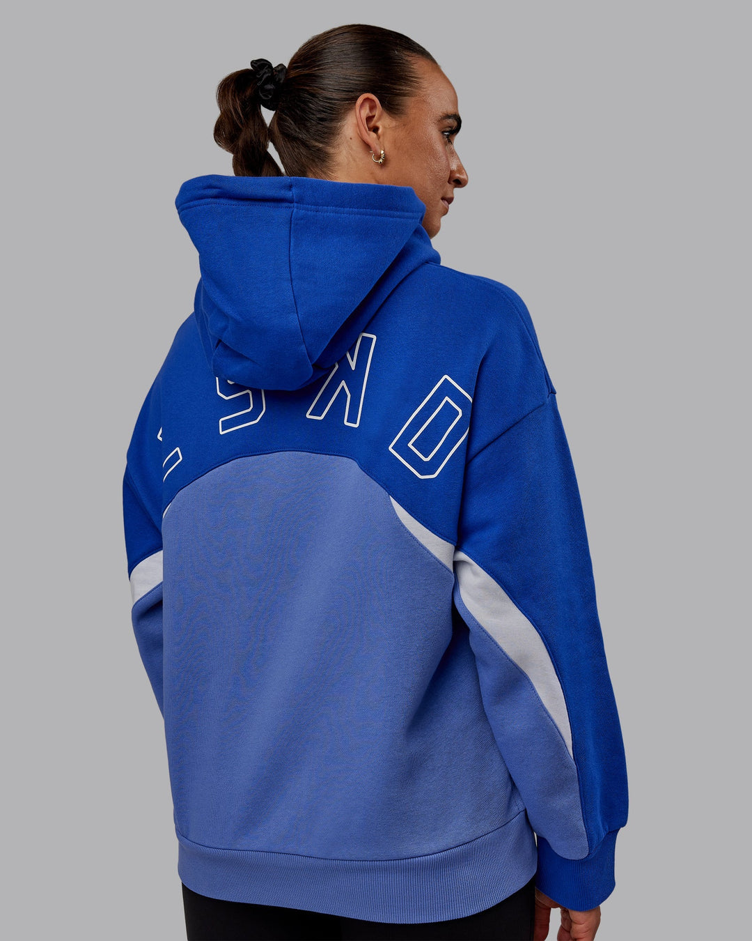 Woman wearing Unisex Y2K Concept Panel Hoodie - Power Cobalt-White