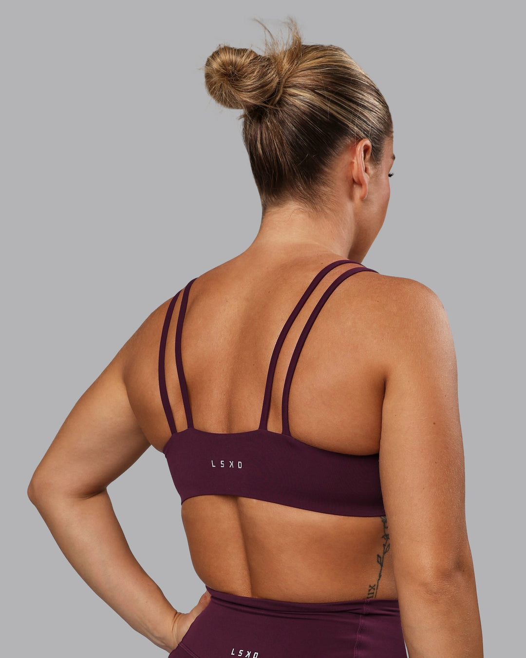 Woman wearing Vantage Sports Bra - Cherry Lacquer