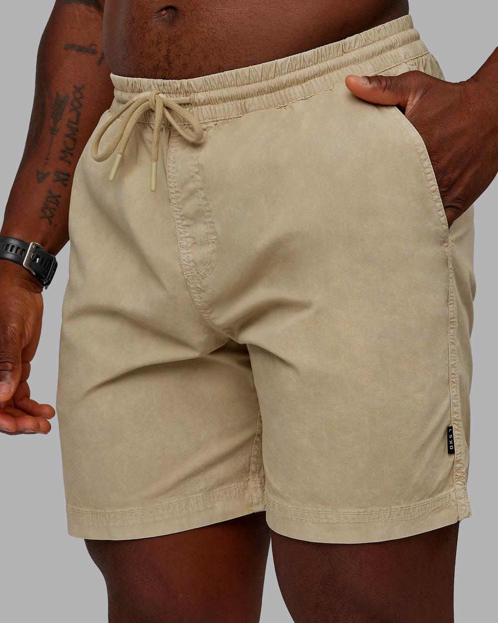 Man wearing Washed Daily 7" Shorts - Pale Khaki