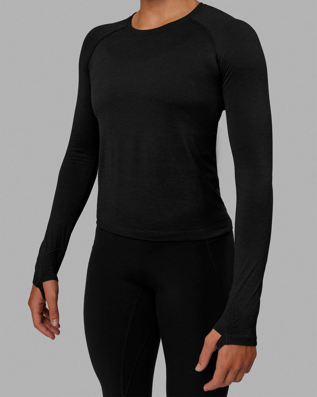 Woman wearing AeroFLX+ Seamless Long Sleeve Tee - Black Marl