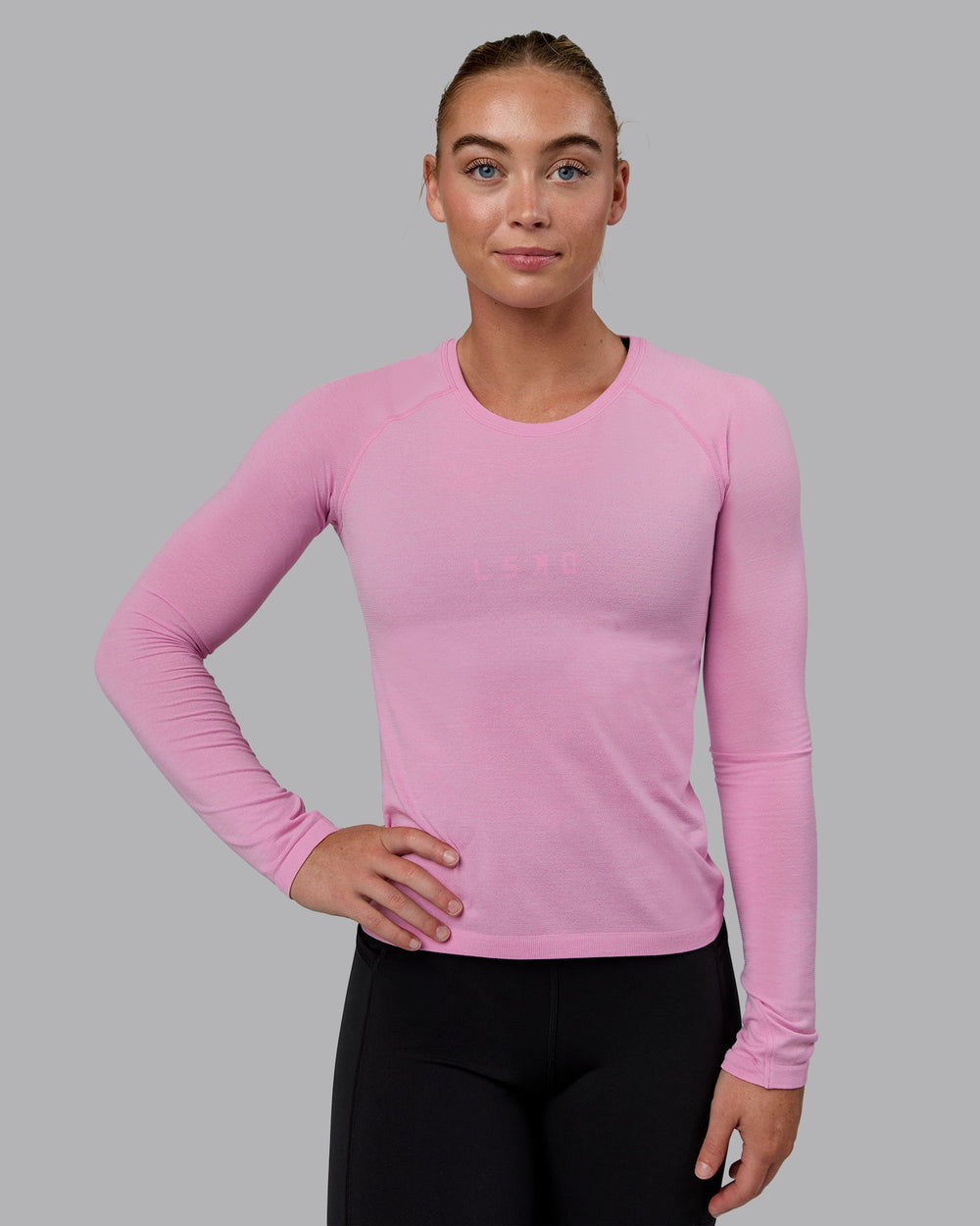 Woman wearing AeroFLX+ Seamless Long Sleeve Tee - Piroutte/Bubblegum