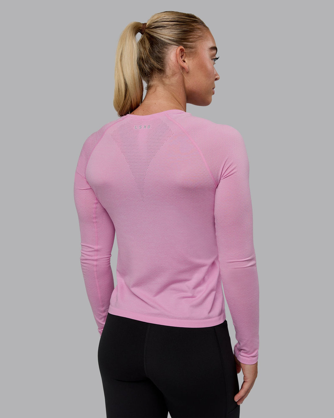 Woman wearing AeroFLX+ Seamless Long Sleeve Tee - Piroutte/Bubblegum