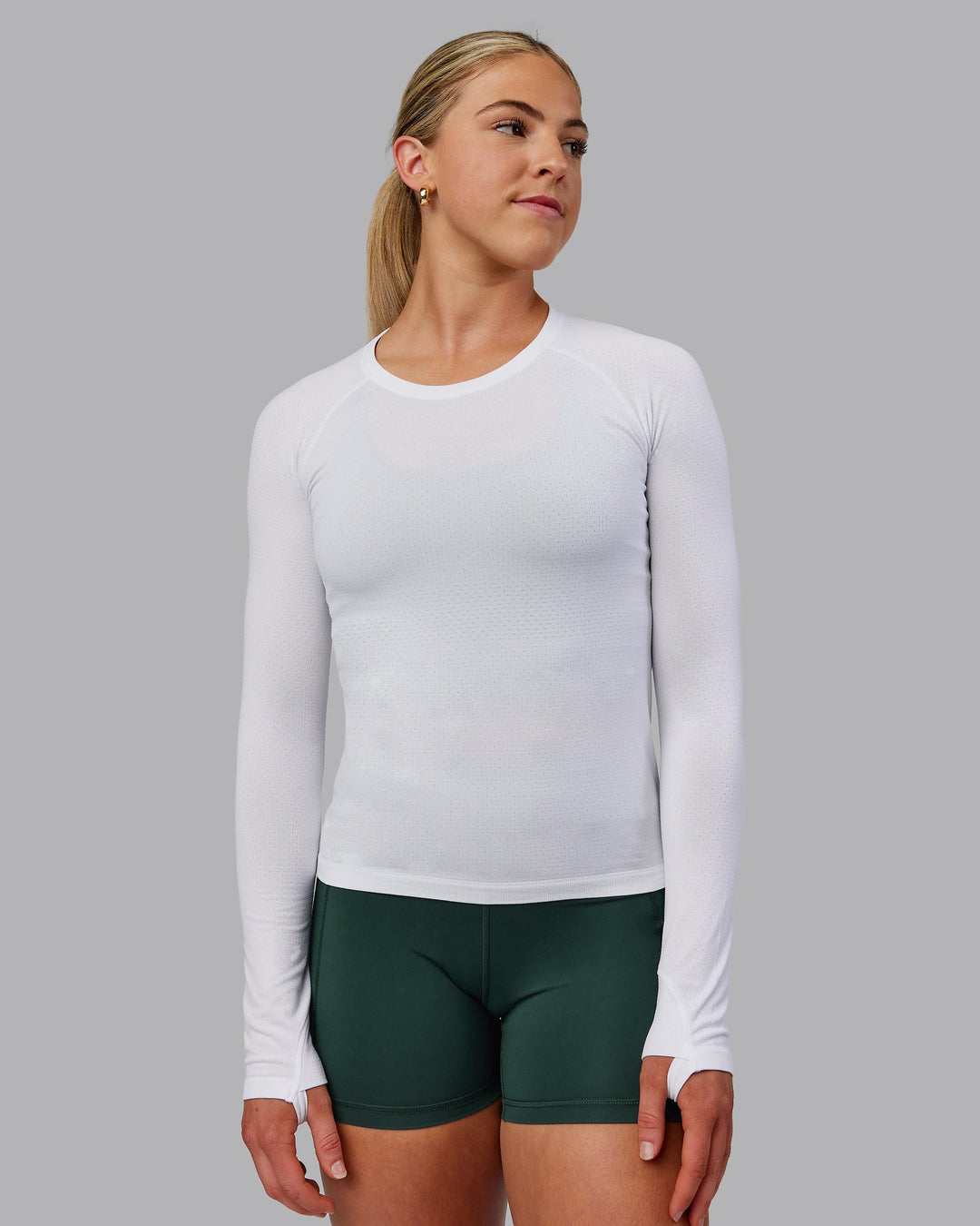 Woman wearing AeroFLX+ Seamless Long Sleeve Tee - White/White