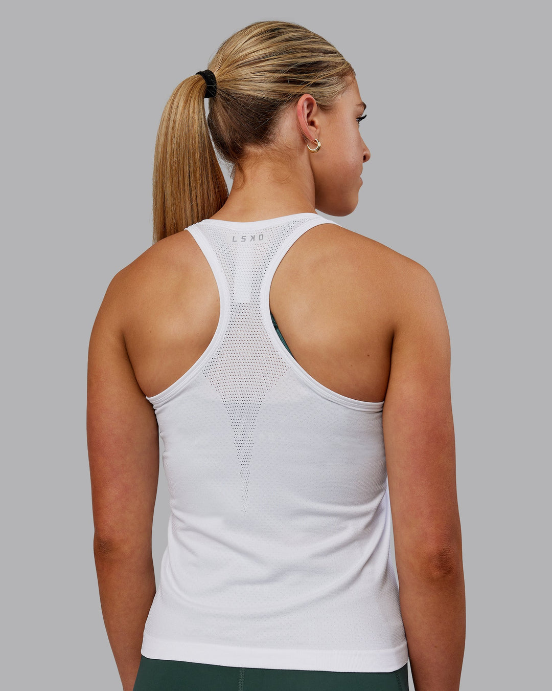 Woman wearing AeroFLX+ Seamless Tank - White