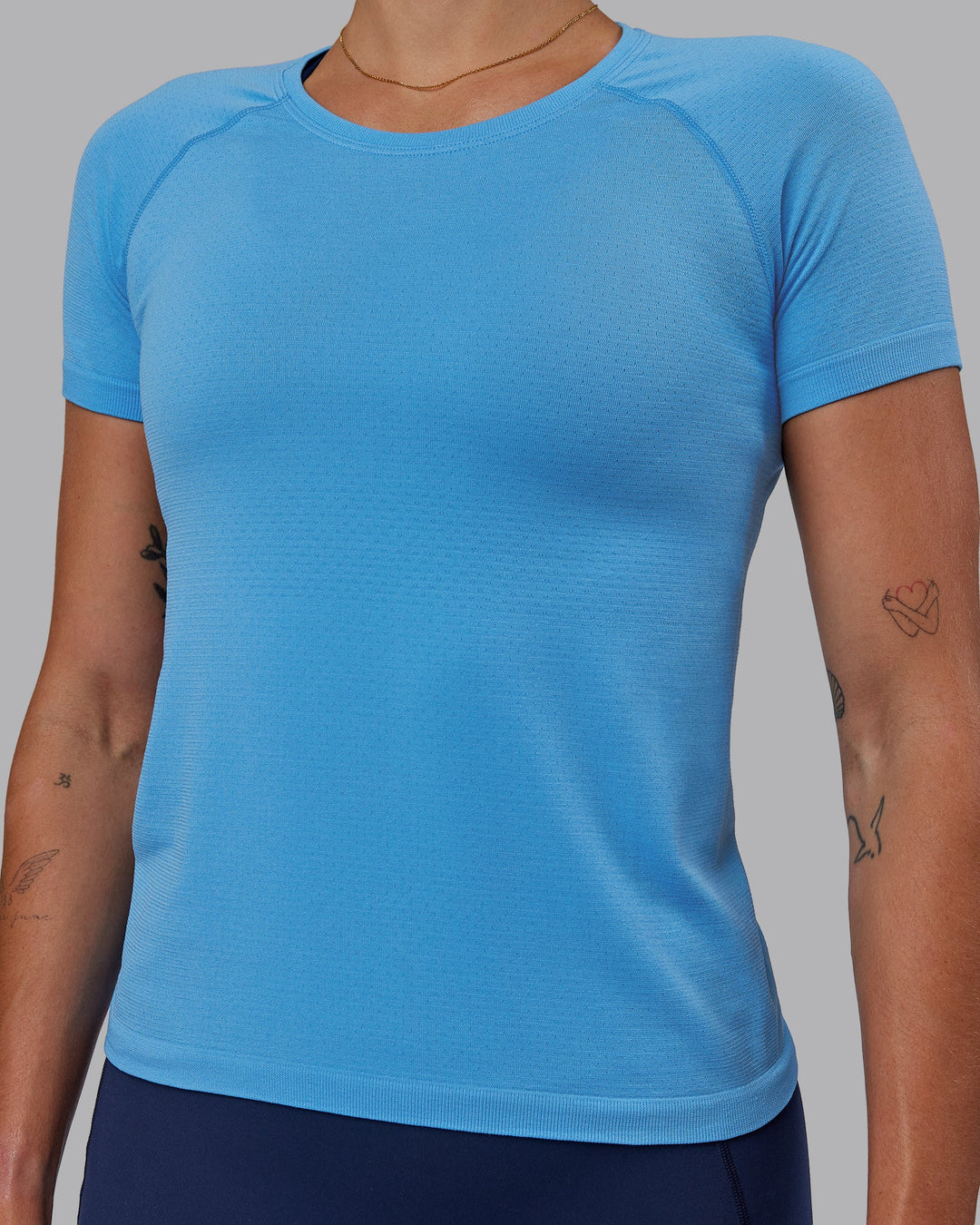 Woman wearing AeroFLX+ Seamless Tee - Azure Blue