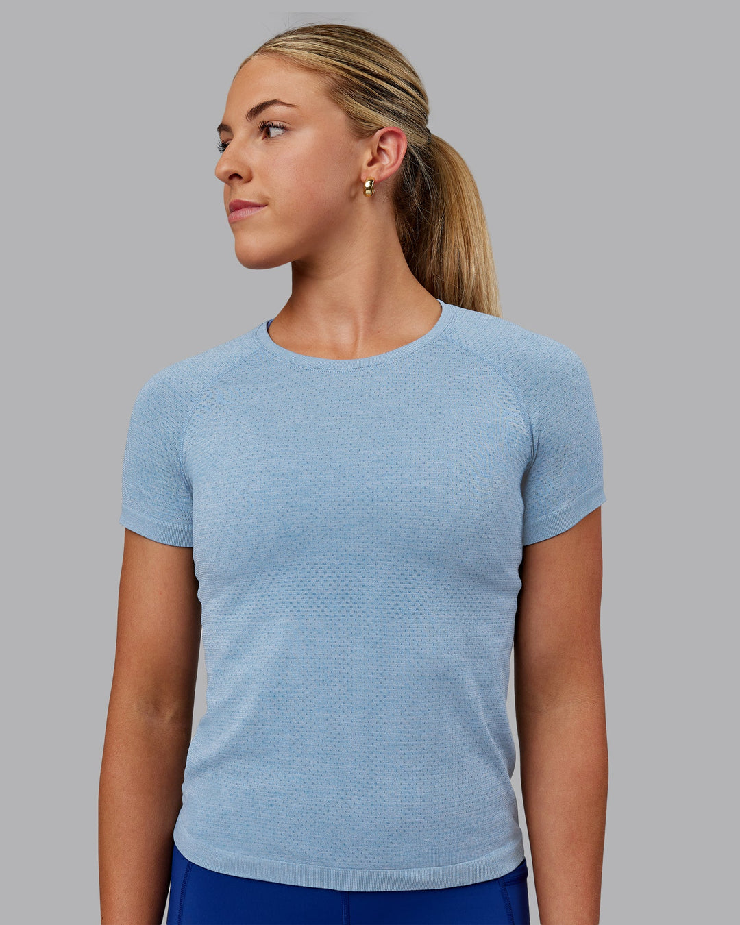 Woman wearing AeroFLX+ Seamless Tee - Elemental Blue/Ice Blue