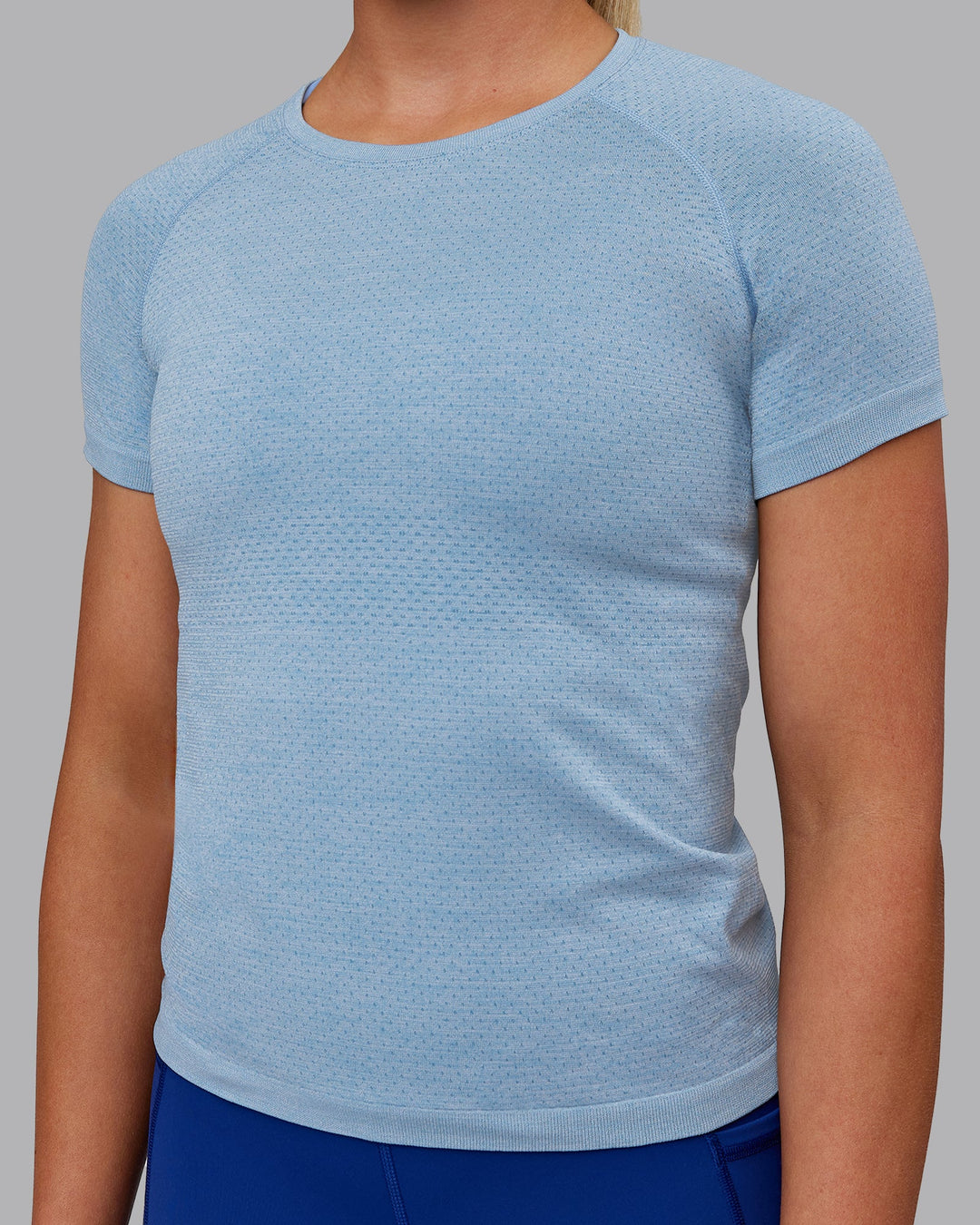 Woman wearing AeroFLX+ Seamless Tee - Elemental Blue/Ice Blue