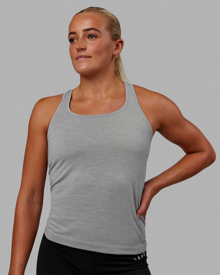 Woman wearing AeroFLX+ Seamless Tank - Light Grey Marl
