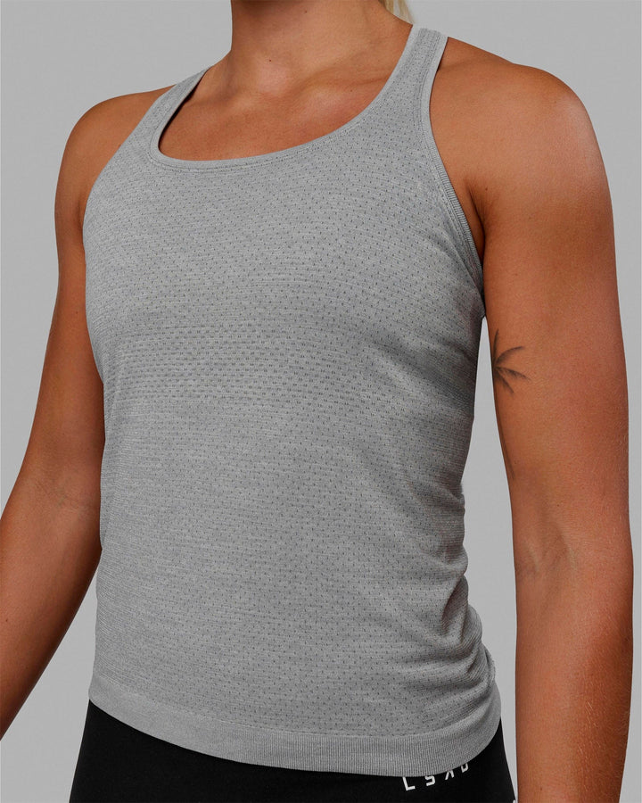 Woman wearing AeroFLX+ Seamless Tank - Light Grey Marl
