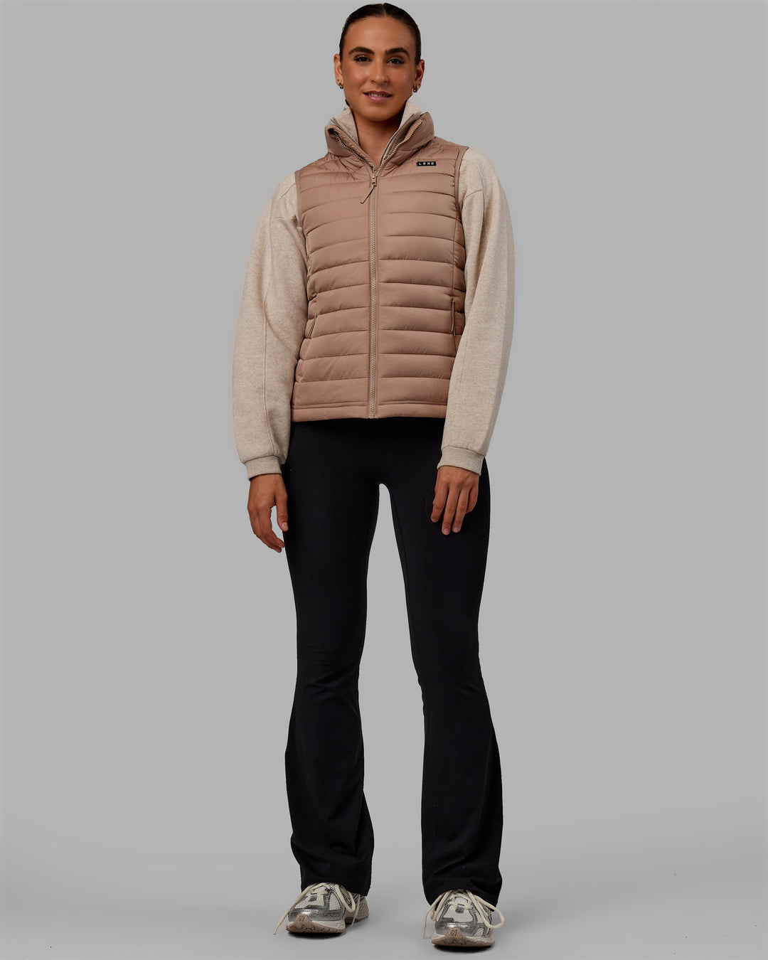 Woman wearing All Day Puffer Vest - Desert