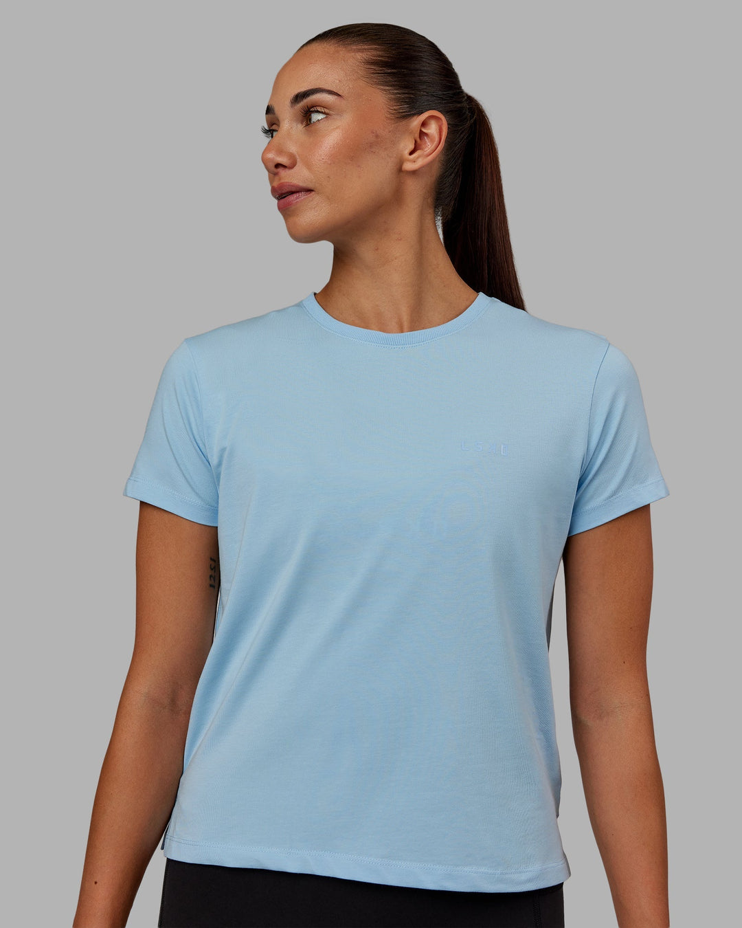 Woman wearing Deluxe PimaFLX Tee - Glacial Blue