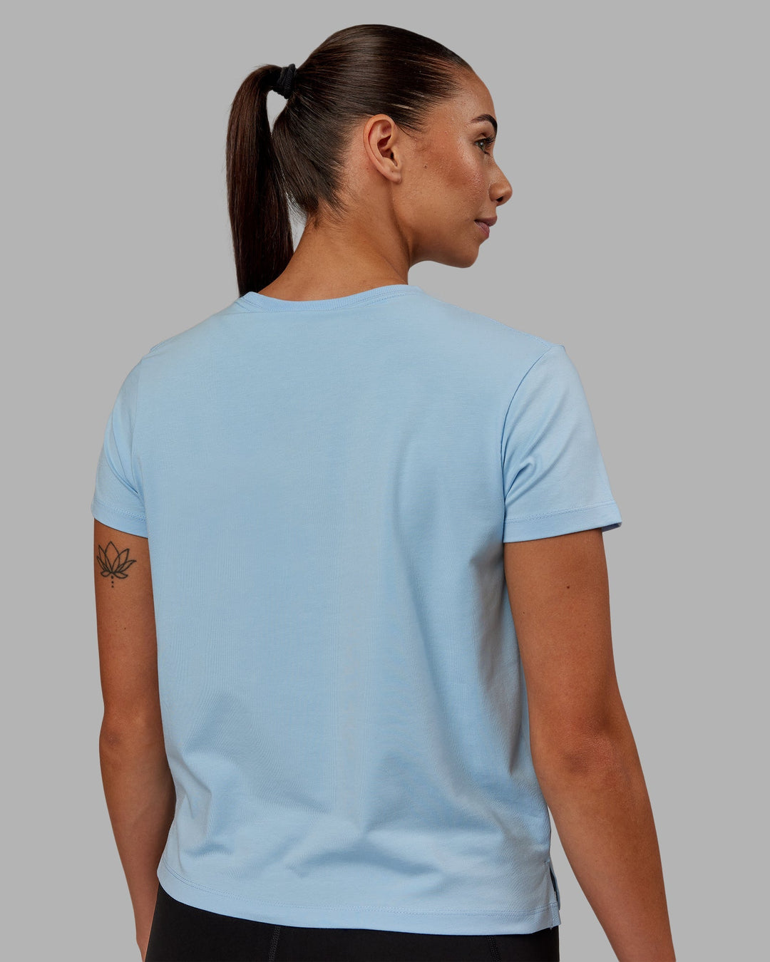 Woman wearing Deluxe PimaFLX Tee - Glacial Blue