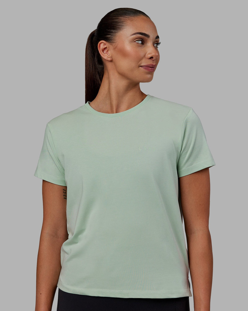 Woman wearing Deluxe PimaFLX Tee - Surf Spray