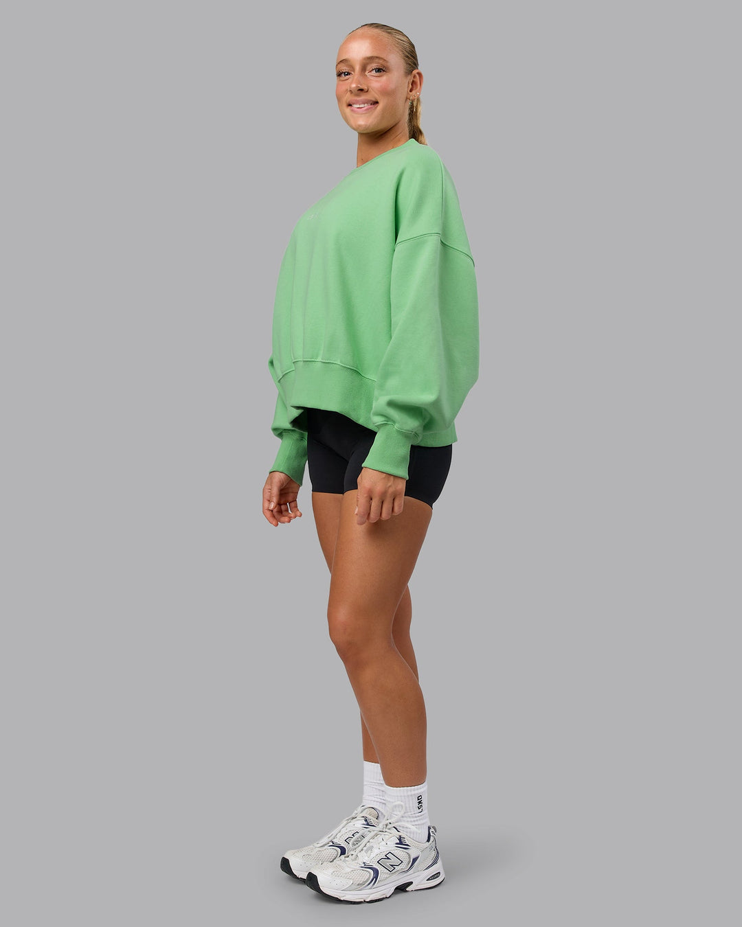 Woman wearing MVP Oversized Sweater - Surreal Green