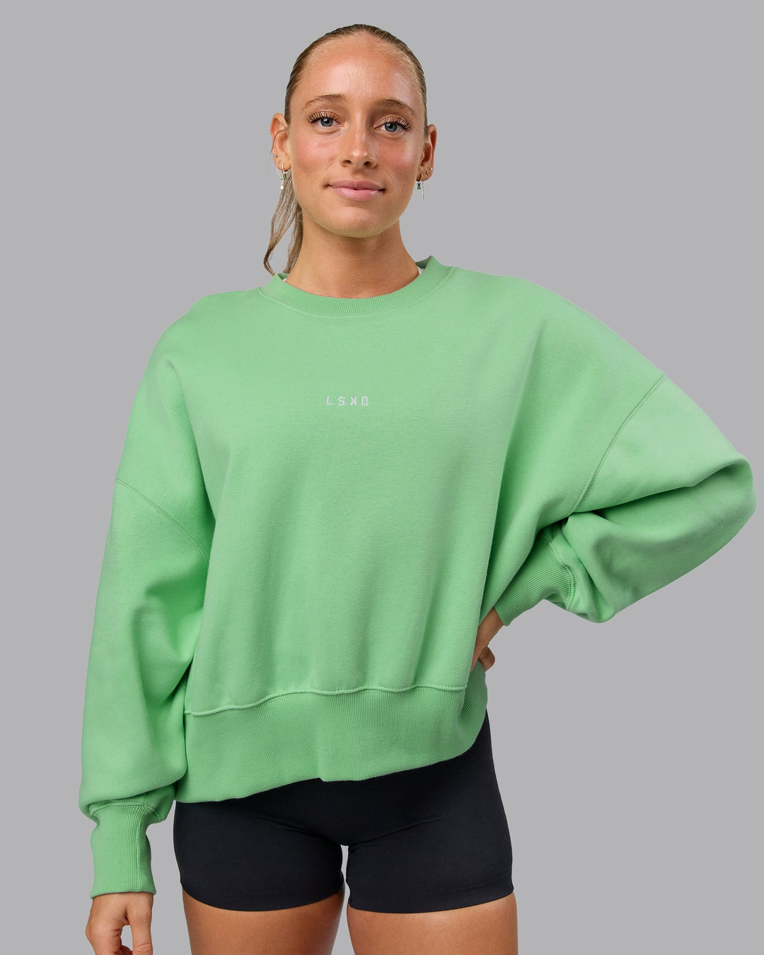 Woman wearing MVP Oversized Sweater - Surreal Green