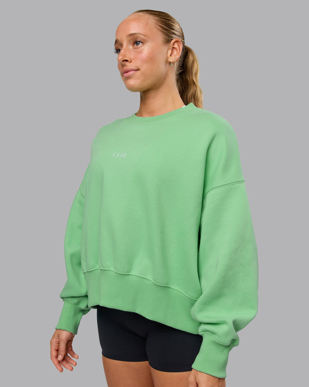 Woman wearing MVP Oversized Sweater - Surreal Green