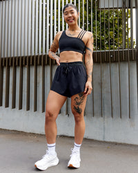 Woman wearing Accelerate 3" High-Rise Running Short - Black | Model:Beccie | Size:S