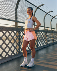 Woman wearing Accelerate 3" High-Rise Running Short - Cantaloupe-Marshmallow | Model:Jasynta | Size:S