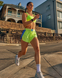 Woman wearing Accelerate 3" High-Rise Running Short - Electric Indigo-Lime Glo | Model:Jasynta | Size:S