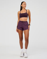 Woman wearing Accelerate 3" High-Rise Running Short - Midnight Plum | Model:Rhiley | Size:S