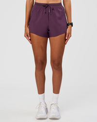Woman wearing Accelerate 3" High-Rise Running Short - Midnight Plum | Set:true | Angle:front | Model:Rhiley | Size:S