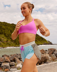Woman wearing Accelerate 3" High-Rise Running Short - Taupe Ash-Glacial Blue | Model:Ella | Size:S