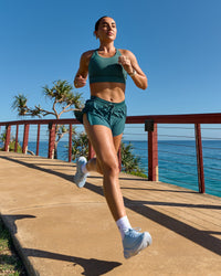 Woman wearing Accelerate 3" Mid-Rise Running Short - Transformative Teal | Model:Libby | Size:S