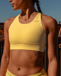 Woman wearing Accelerate Sports Bra - Lemon | Model:Vanessa | Size:S