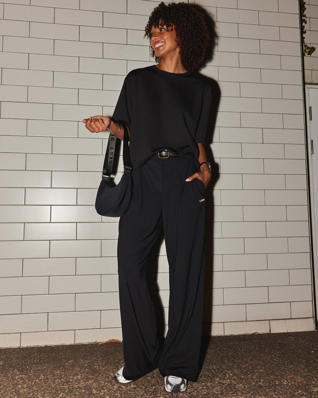 Woman wearing AfterDark ZeroCrease Cropped Tee - Black | Model:Tomi | Size:S