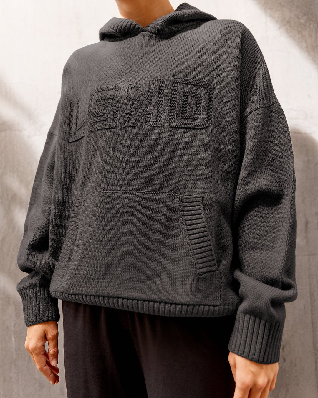 Woman wearing All Day Active Knitted Hoodie - Dark Storm | Size:S
