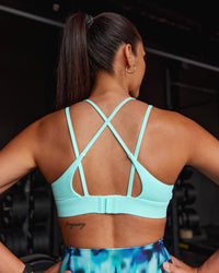 Woman wearing Aria Triangle Sports Bra - Island Paradise | Model:Rhiley | Size:S | Thumbnail Index: 0