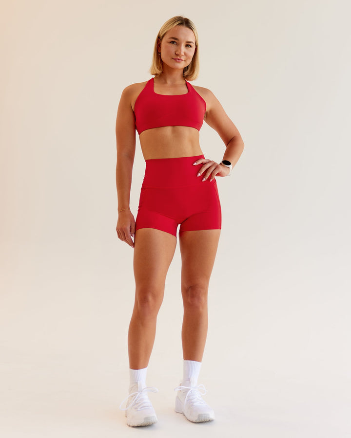 Woman wearing Aspire Sports Bra in Flame | Size:S
