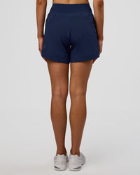 Woman wearing Challenger 5" Lined Performance Short - Future Navy | Model: Evie | Size:S