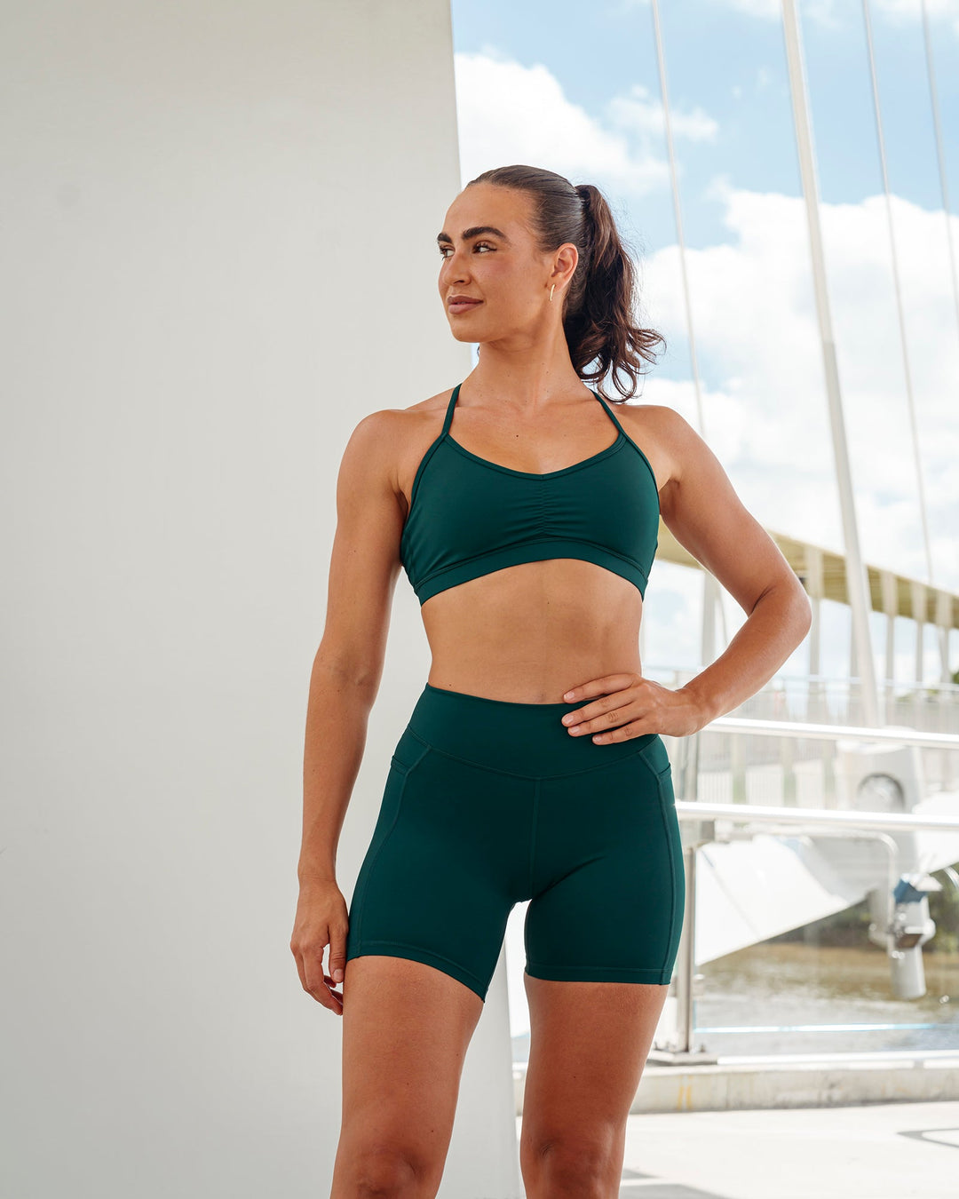 Woman wearing Clarity Sports Bra in Dark Moss | Size:S